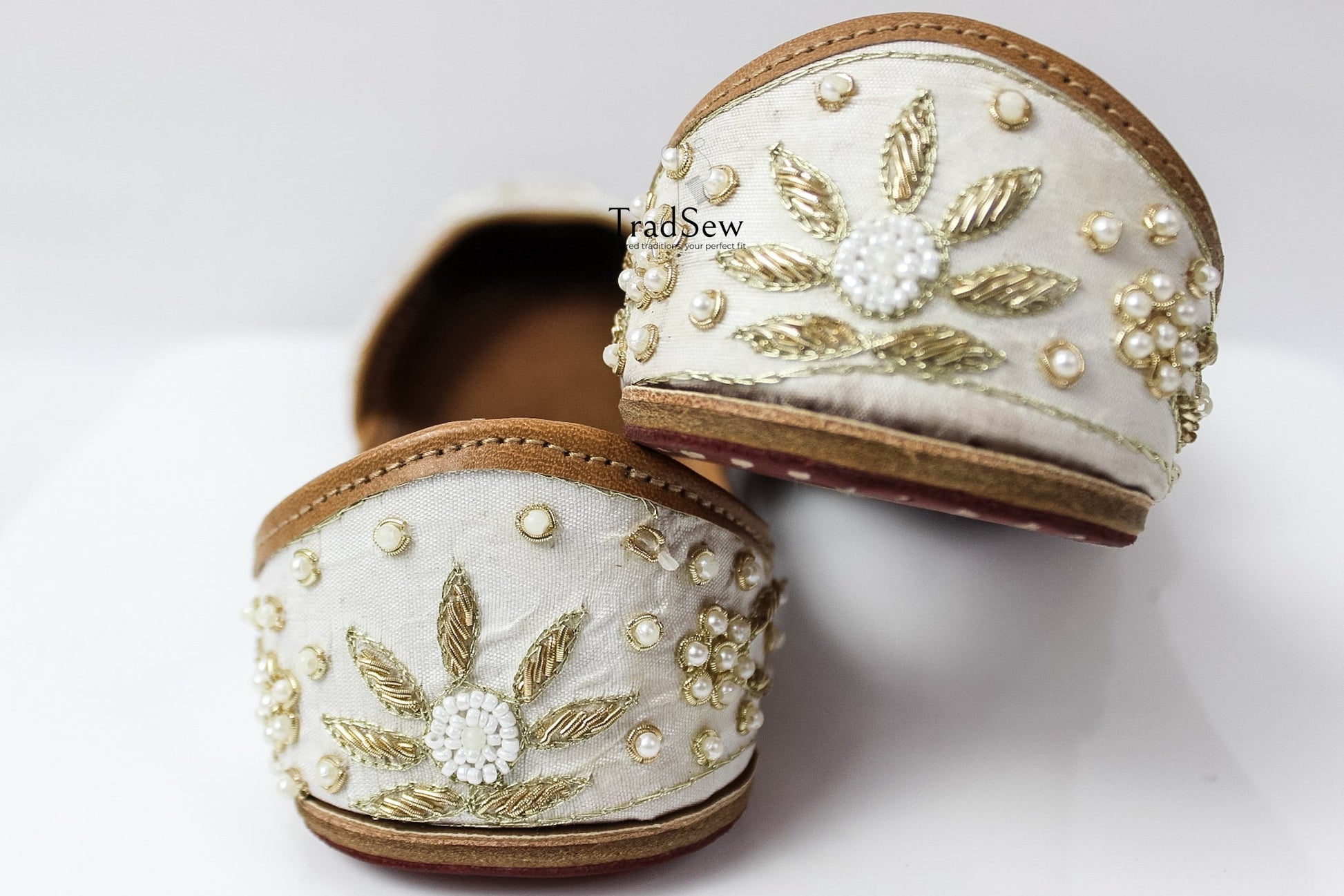 White and golden designer jutti with stonework embroidery by Tradsew