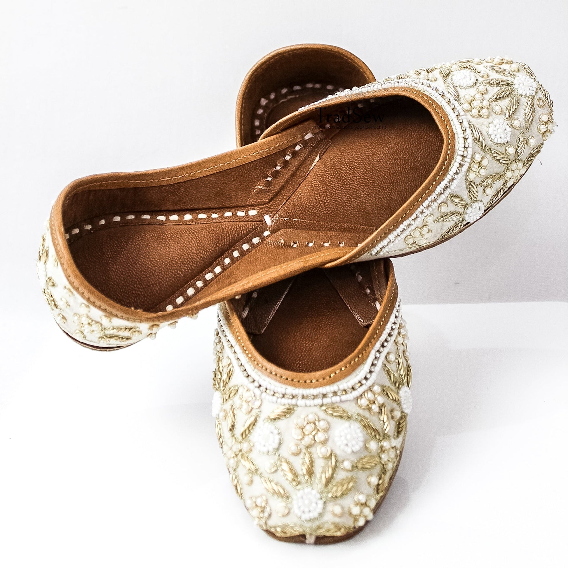 White and golden designer jutti with stonework embroidery by Tradsew
