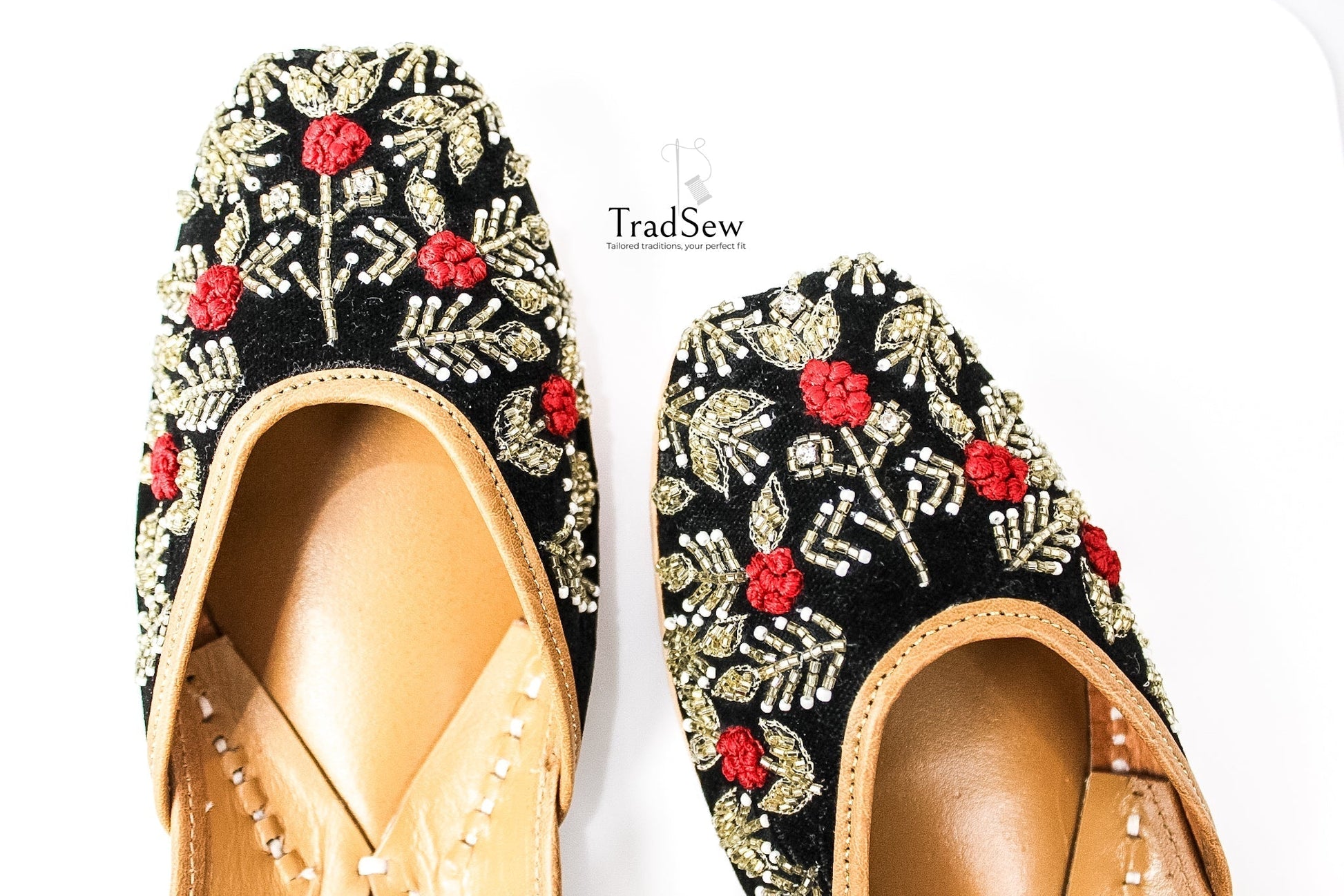 Black jutti with red and white flower stonework design by Tradsew