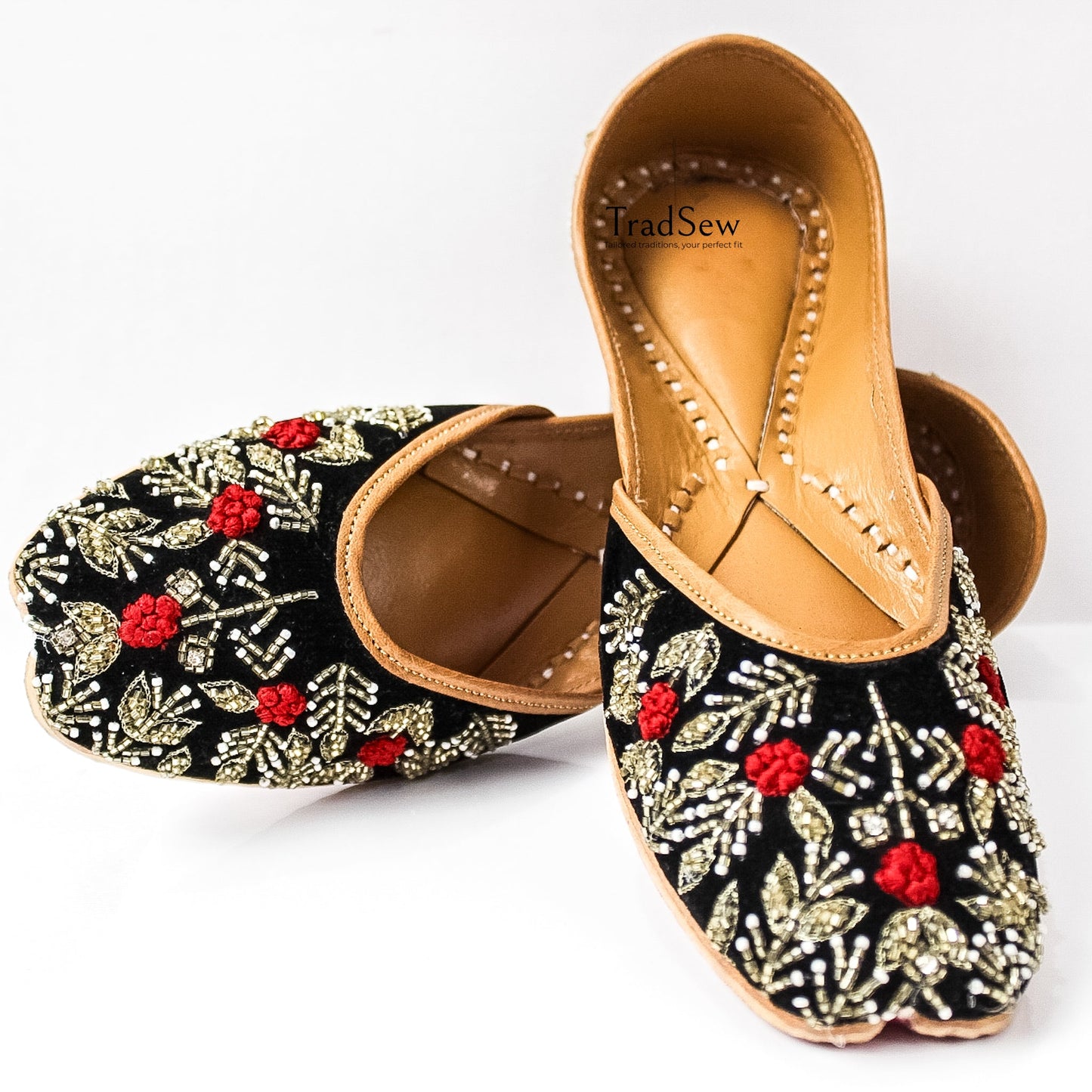 Black jutti with red and white flower stonework design by Tradsew
