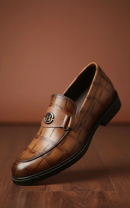 Brown leather loafer on a wooden surface with a brown background
