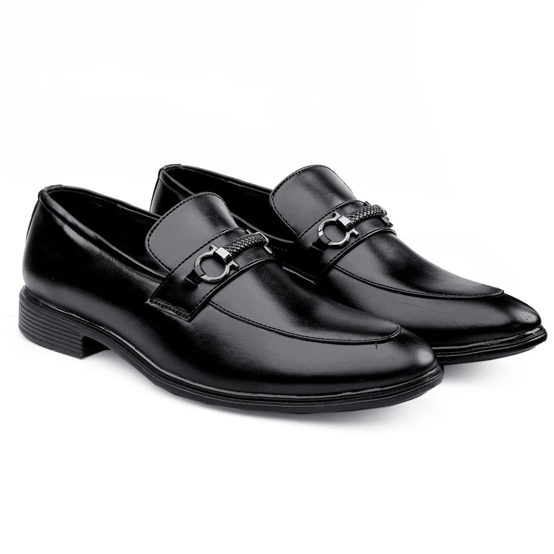 Pair of black dress shoes with a silver buckle on a white background