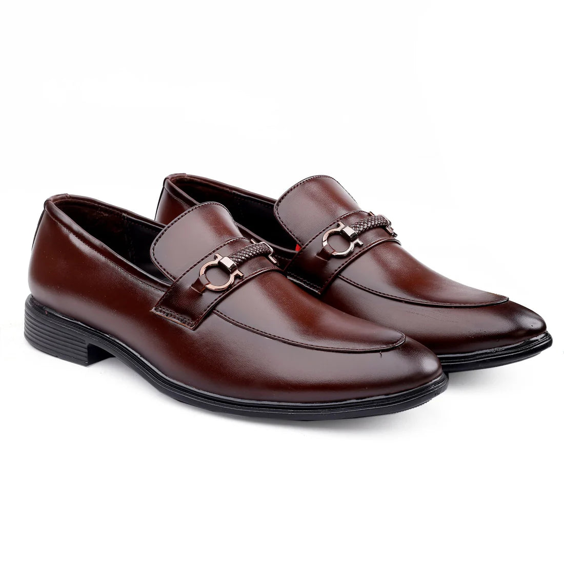A pair of brown leather loafers with a metal buckle and strap detail on a white background.