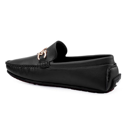 Black loafer with a metal embellishment on the strap and a round toe style.