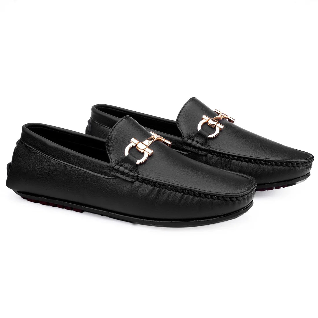 Pair of black loafers with rose gold accents on a white background