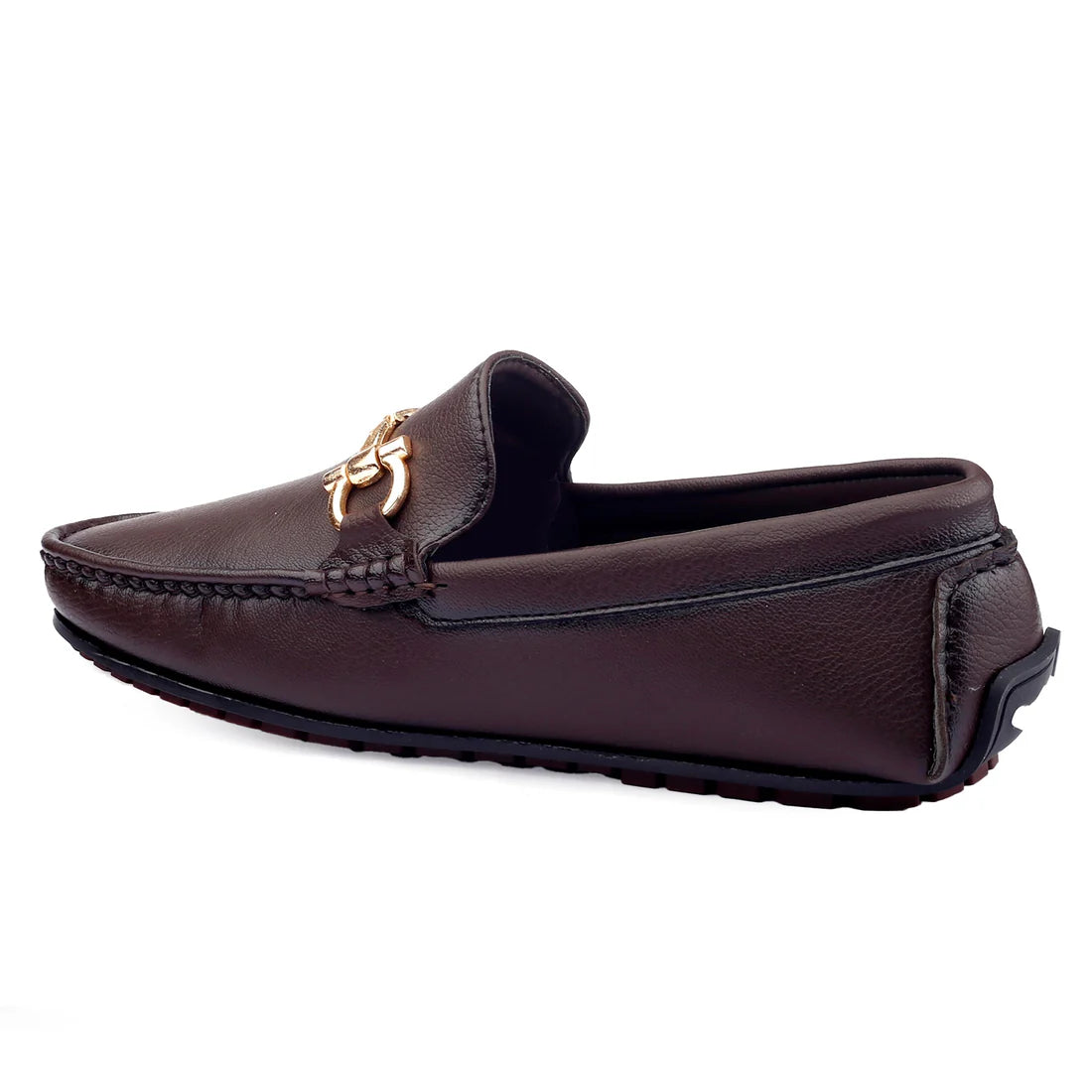 A brown loafer shoe with a metal decoration on the strap, viewed from the side.