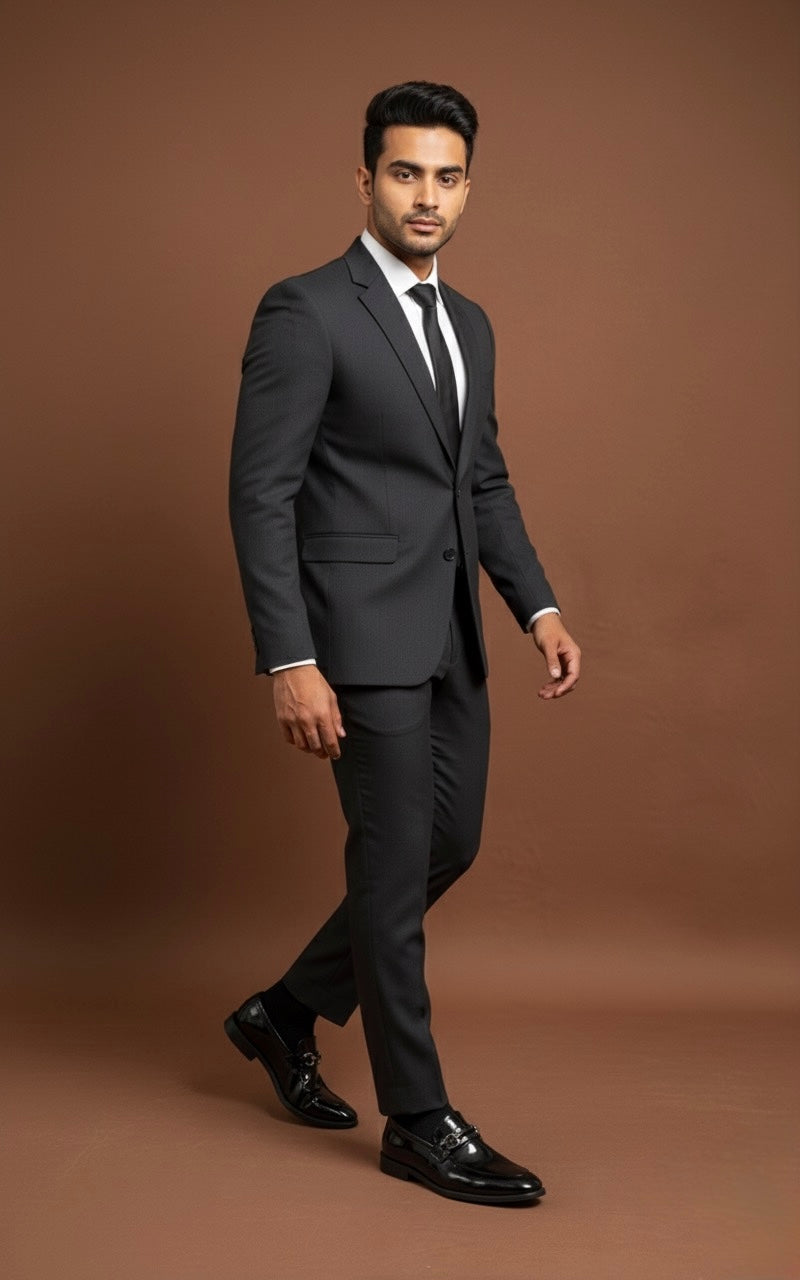 Man wearing a black suit on a brown background