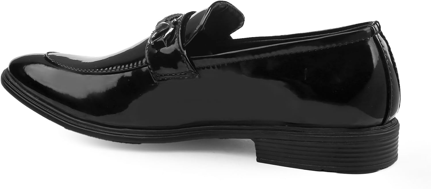 Black patent leather loafer on a white background