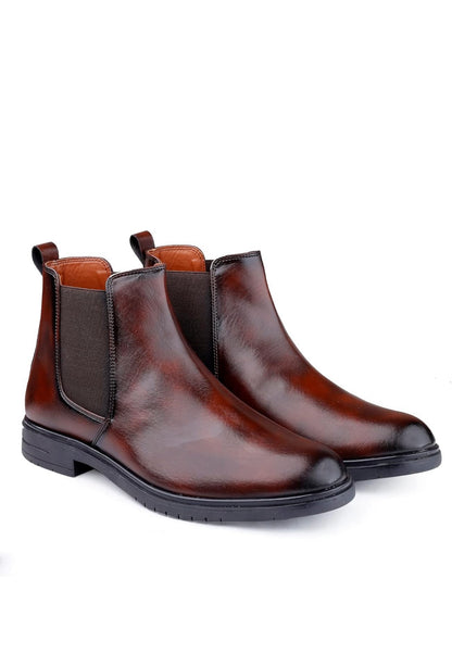 Pair of brown leather Chelsea boots on a white background