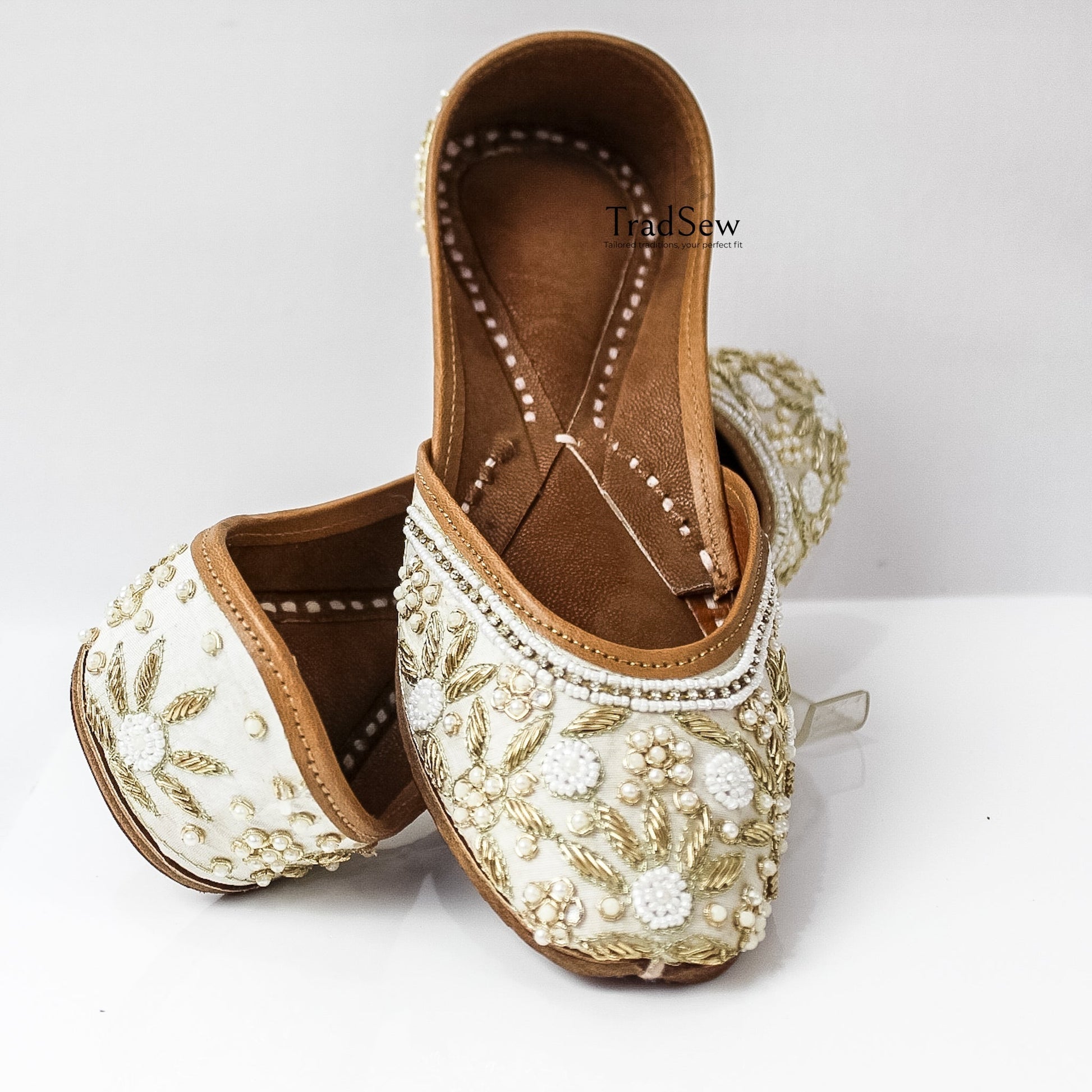 White and golden designer jutti with stonework embroidery by Tradsew