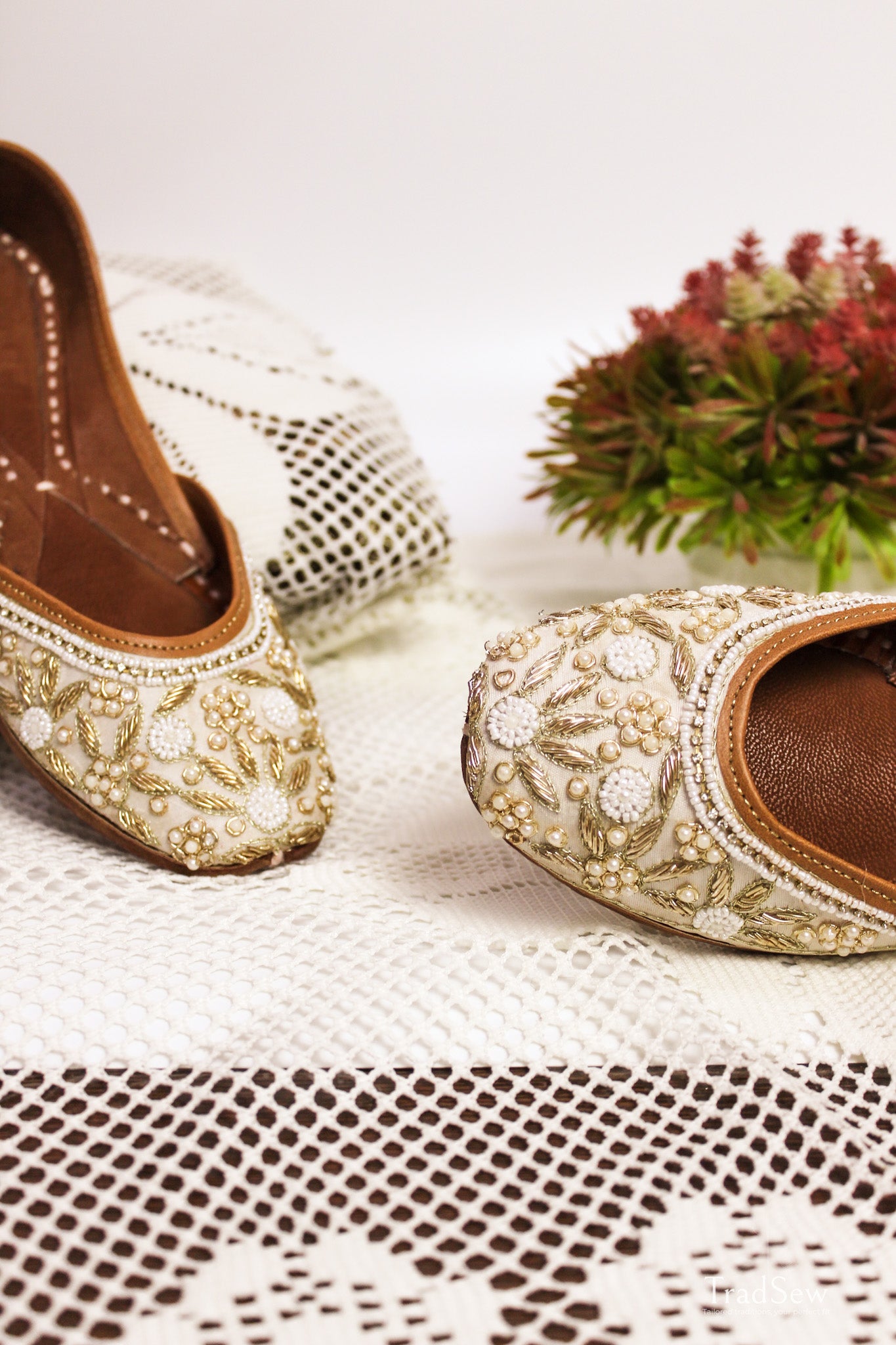White and golden designer jutti with stonework embroidery by Tradsew