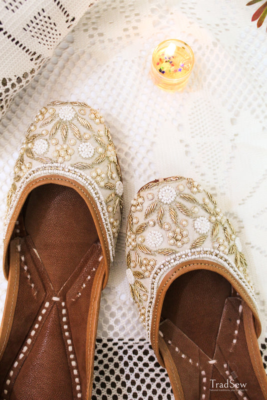 White and golden designer jutti with stonework embroidery by Tradsew